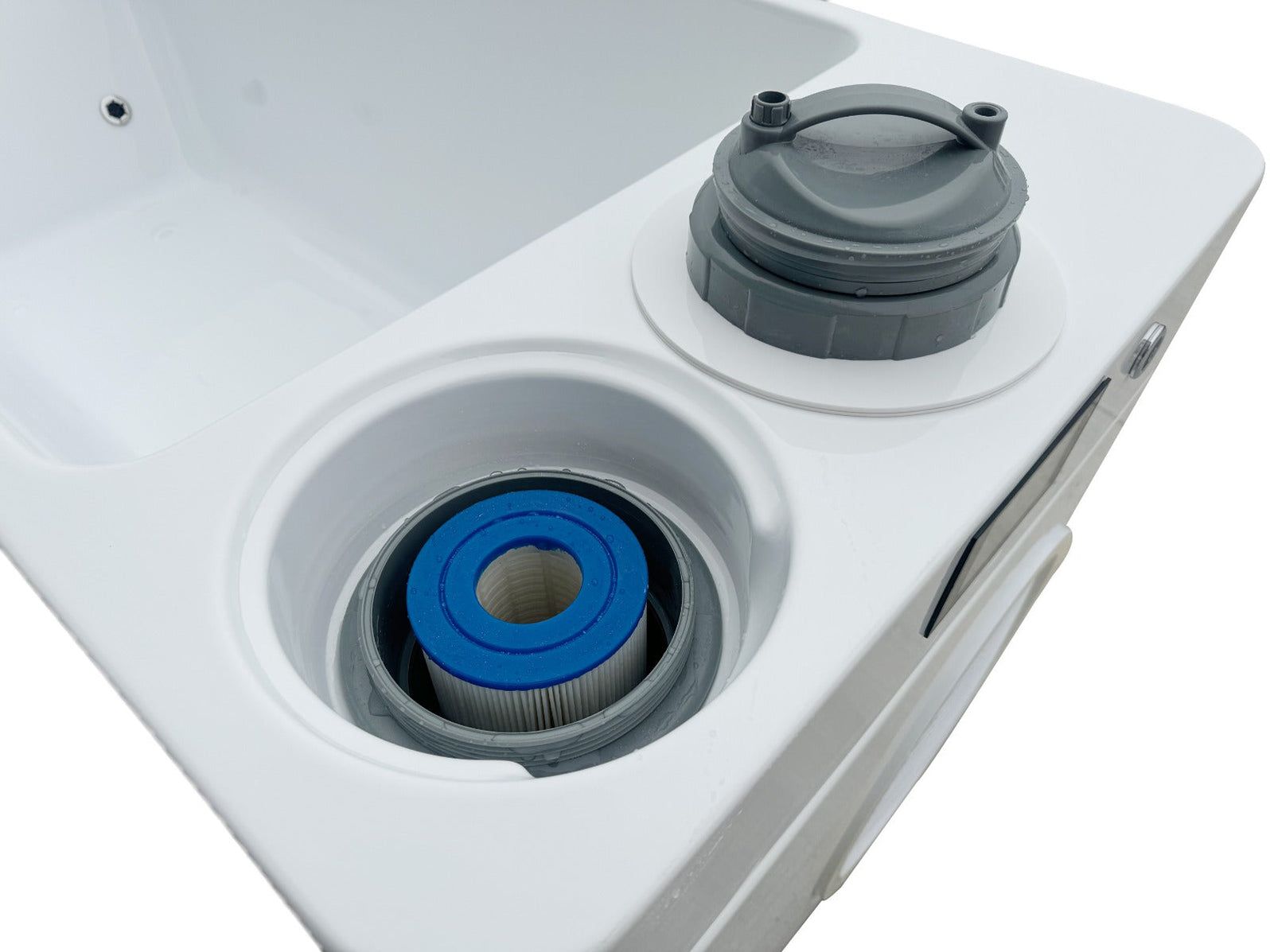 White appliance top with two circular openings, one showing a blue filter and the other a gray cap.