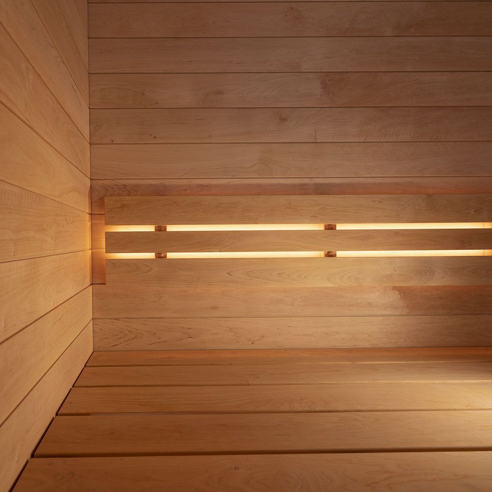 Wood-paneled room with warm horizontal light strips along the wall and floor