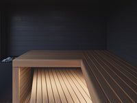 Modern wooden table in a dimly lit room with a dark wall and striped floor pattern