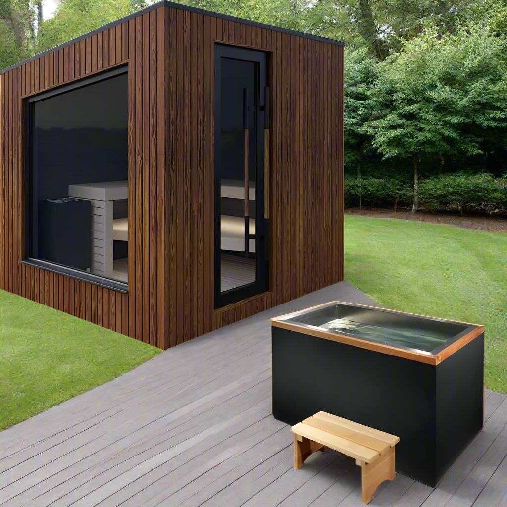 Modern backyard sauna with wood siding beside a deck and outdoor hot tub in a grassy garden.
