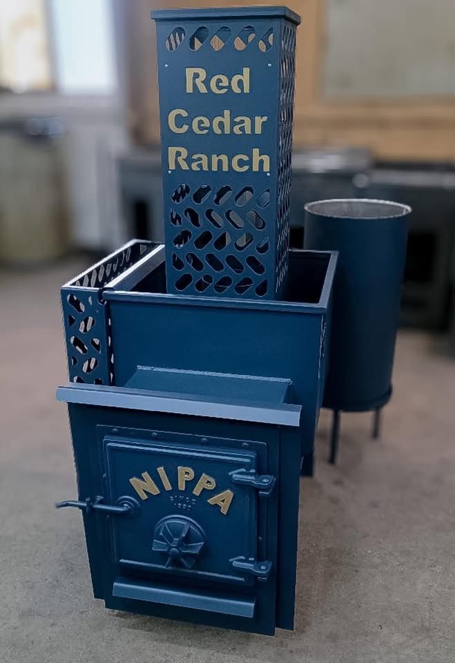 Blue metal mailboxes with decorative cutouts, including one labeled “Red Cedar Ranch” and another “NIPA”