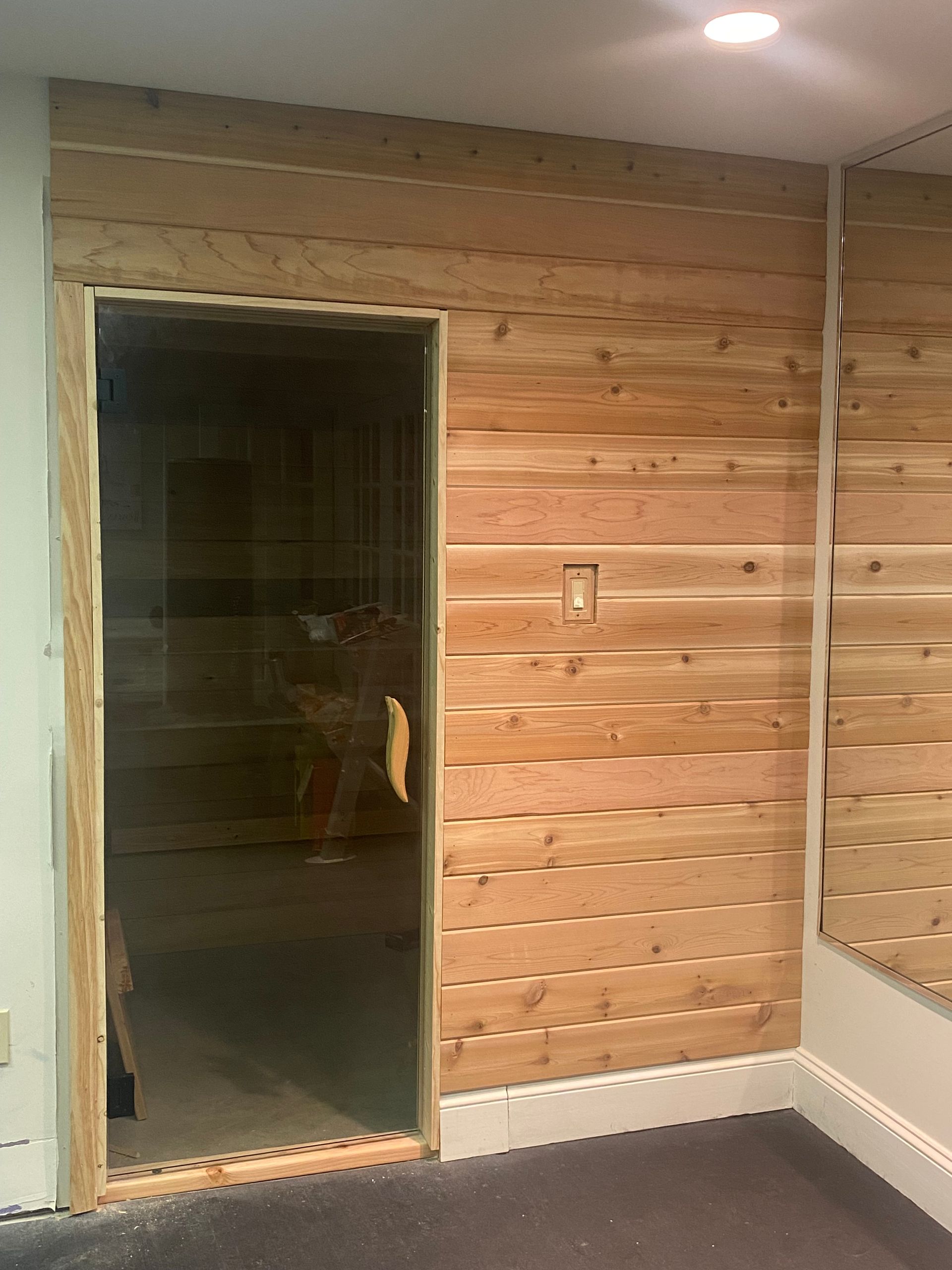 Indoor hybrid infrared sauna, inside the gym of a home in Villanova, PA