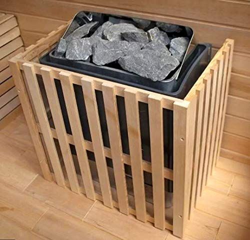 Wooden sauna heater with gray stones on top in a slatted light-wood enclosure