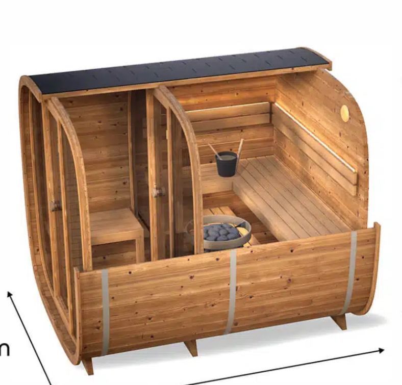 Wooden outdoor sauna barrel with benches, bucket, and stove inside