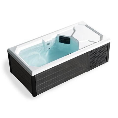 Modern rectangular hot tub with white rim, light blue water, and dark wood-paneled sides