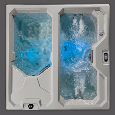Top-down view of a white cold plunge tub with blue water and bubbling jets, split into two sections