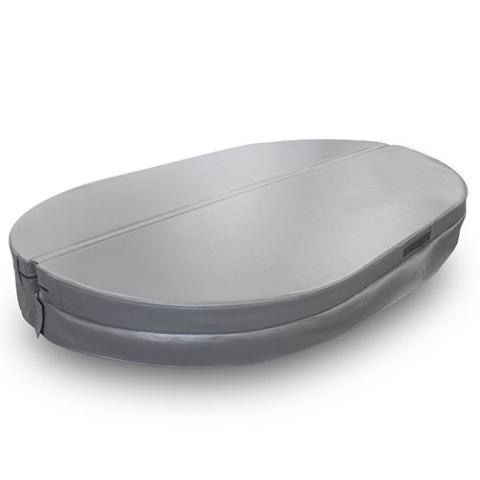 Oval wooden 2 person cold plunge tub with black cover and built-in steps outdoors beside greenery.