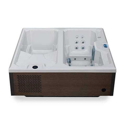Outdoor plunge tub with turquoise water on a wooden deck beside a railing and patio rug.