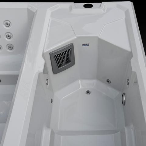 White hot tub interior with molded seats, jets, and a small vent panel