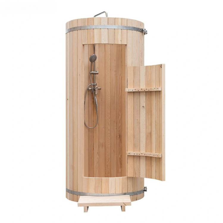 Cylindrical wooden outdoor shower with metal fixtures and a small open side door