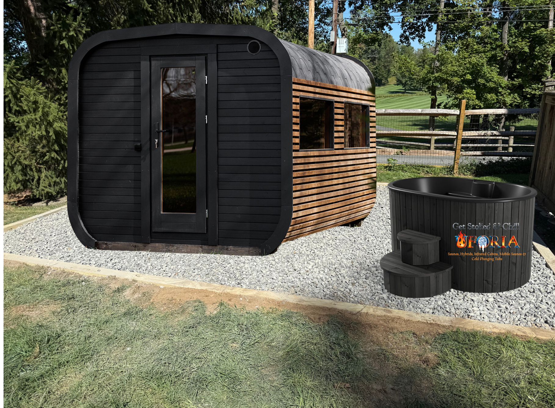 Black barrel sauna and hot tub on gravel in a grassy yard