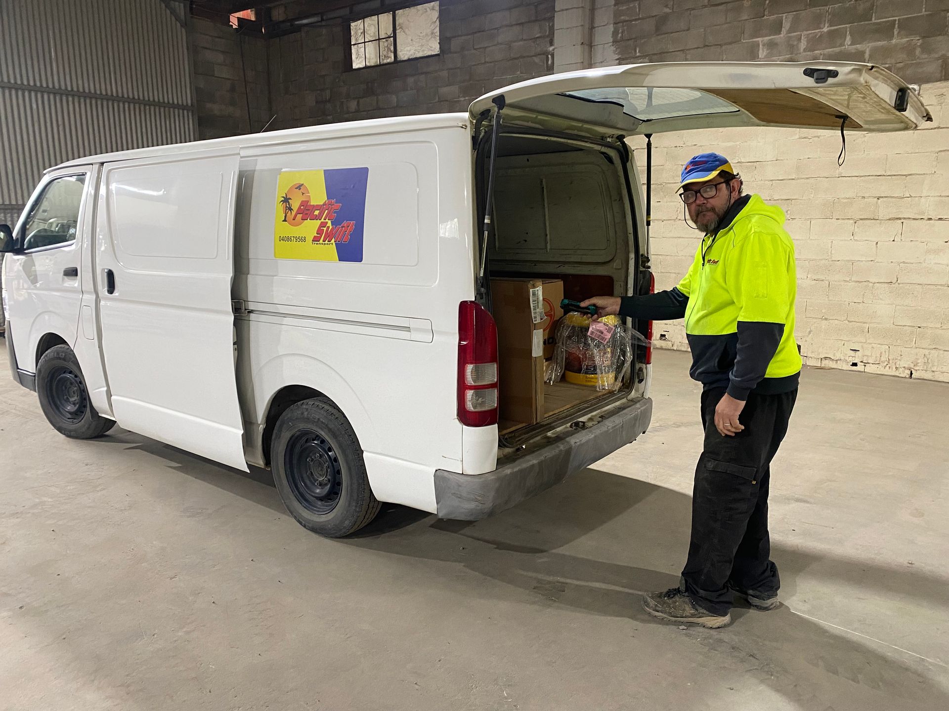 Guy Checking Boxes Inside Truck — Professional Transport in Taree South NSW