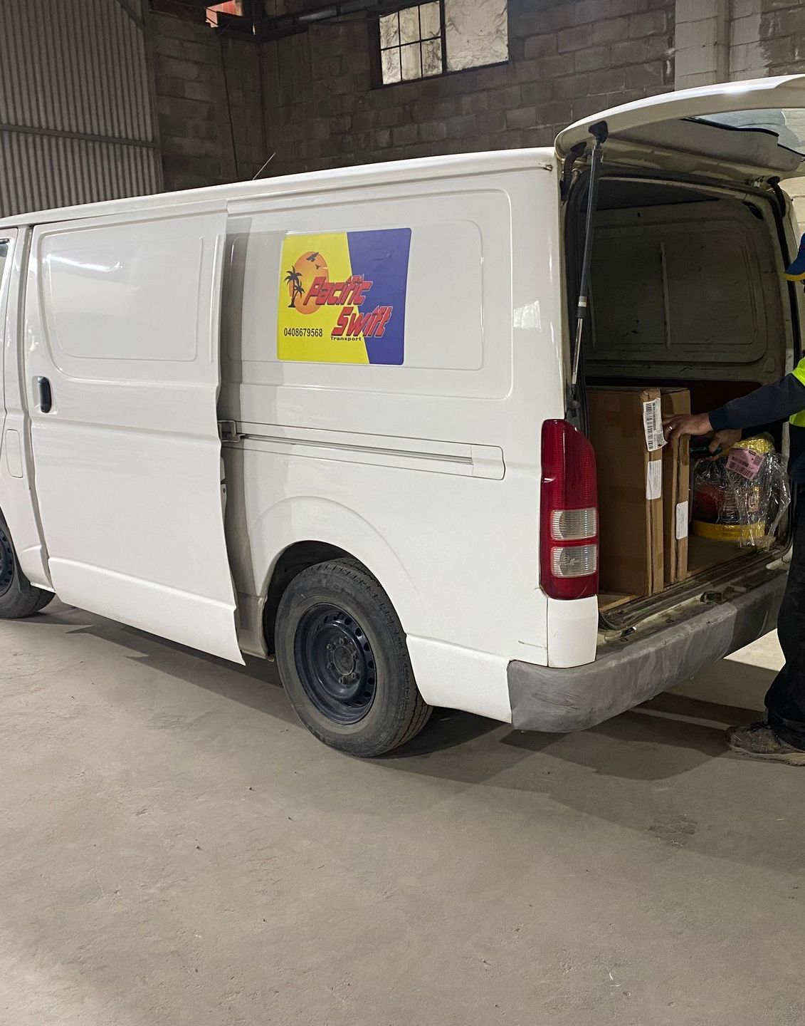 Man Unloading Van With Boxes Inside — Professional Transport in Taree South NSW