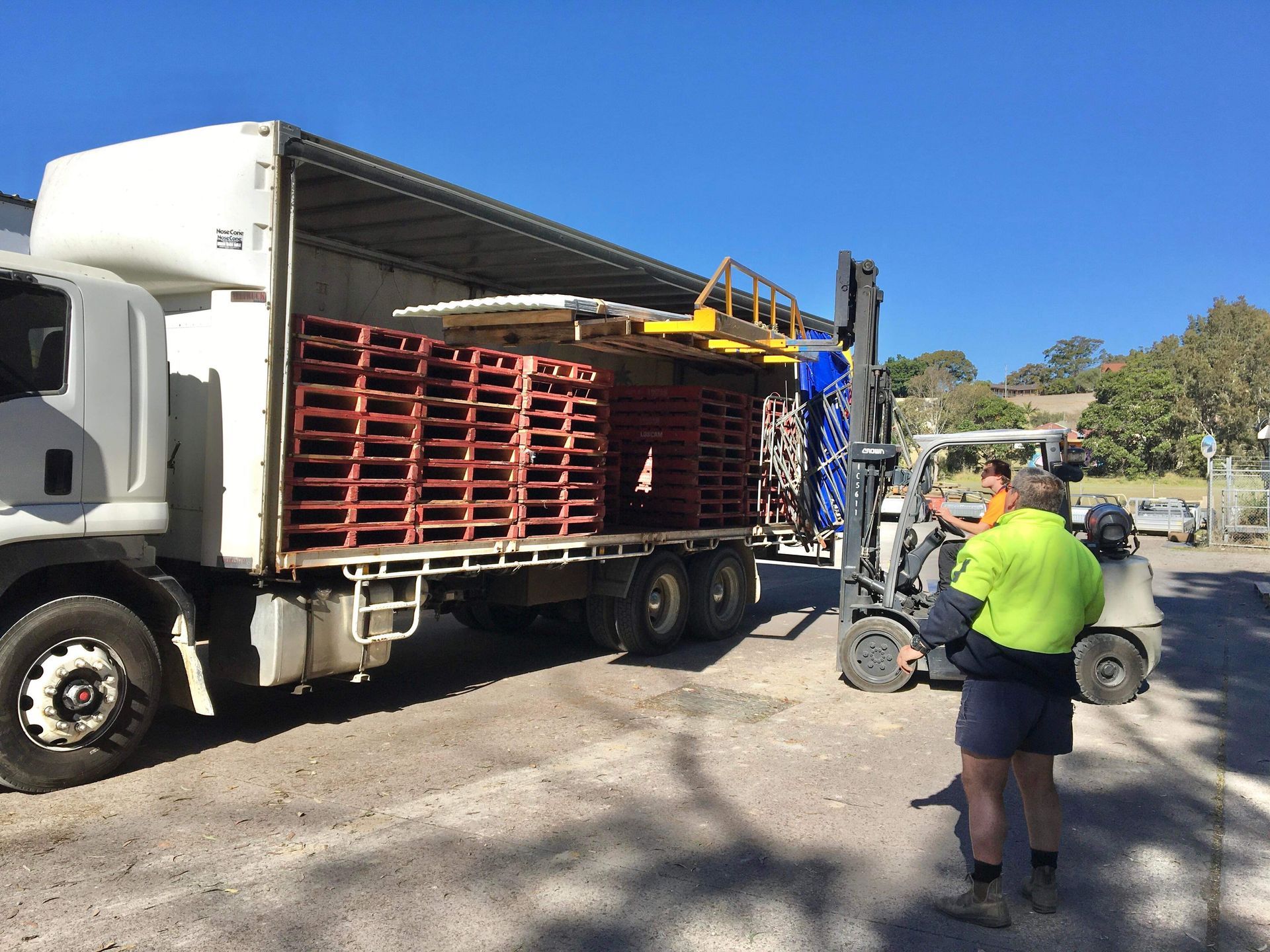 Man Moving Pallets With Forkllift — Professional Transport in Forster, NSW