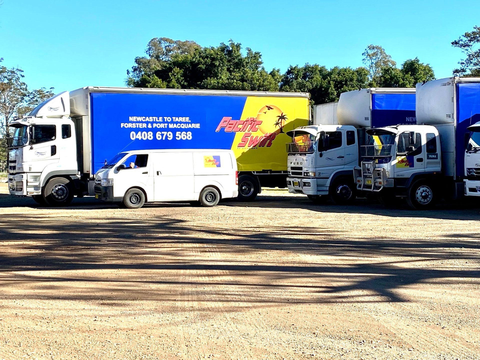 Transport Trucks In A Line And A Van — Professional Transport in Forster, NSW