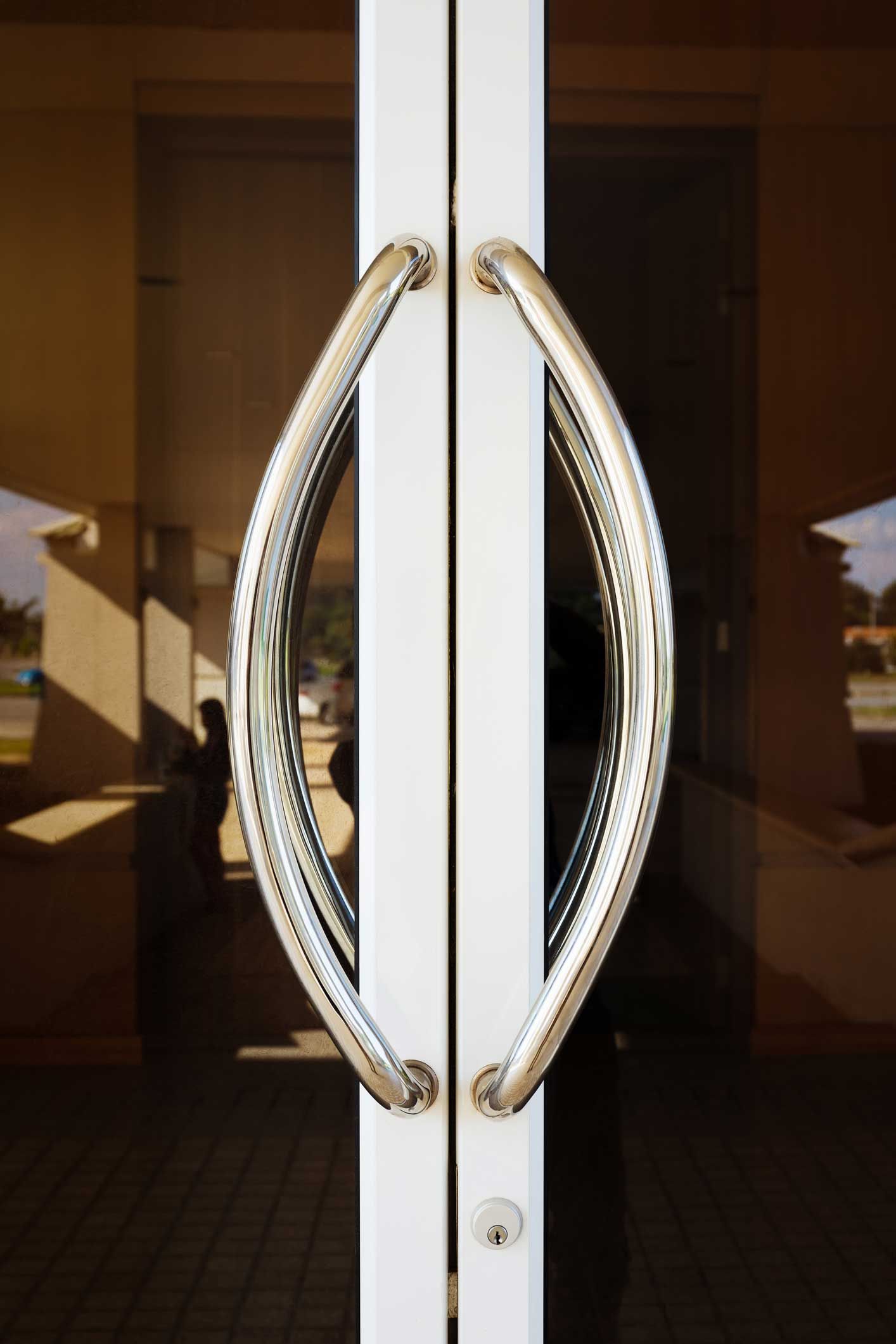 Glass double doors with shiny, curved metal handles.