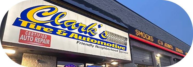 Clear Automotive repair shop sign on a building exterior with blue sky above