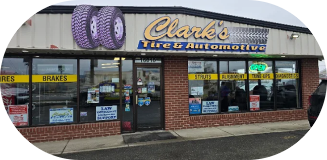 Clark’s Tire & Automotive storefront with tire display and service signs on the windows