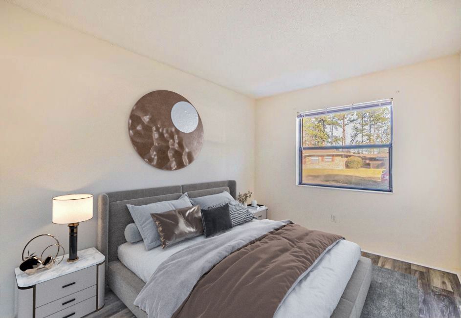 Bedroom with bed, nightstands, window, and decorative wall art.