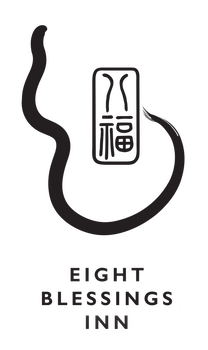 Black logo with stylized snake-like line, Chinese character seal, and the words “EIGHT BLESSINGS INN”