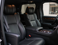 Black leather car interior with front seats and center console in a luxury SUV