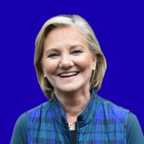 Smiling woman in a blue plaid scarf against a solid blue background