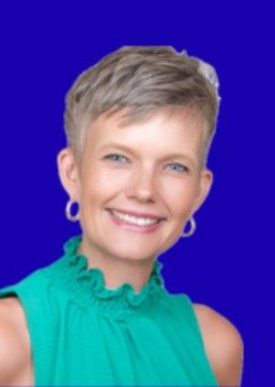 Smiling woman with short blond hair in a teal top against a blue background