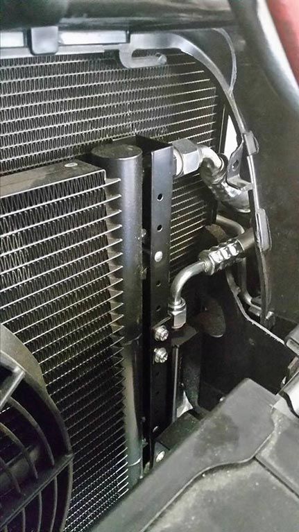 A close up of a radiator on a car with a fan attached to it.