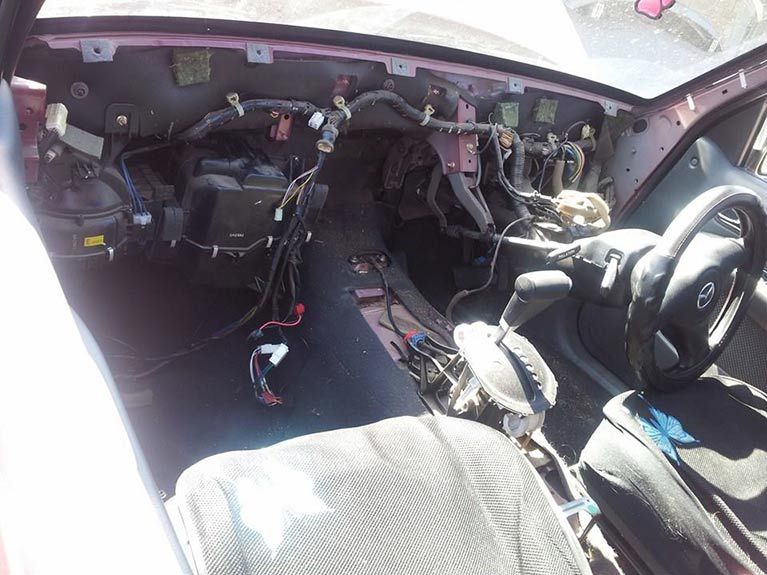 The inside of a car with a lot of wires coming out of it
