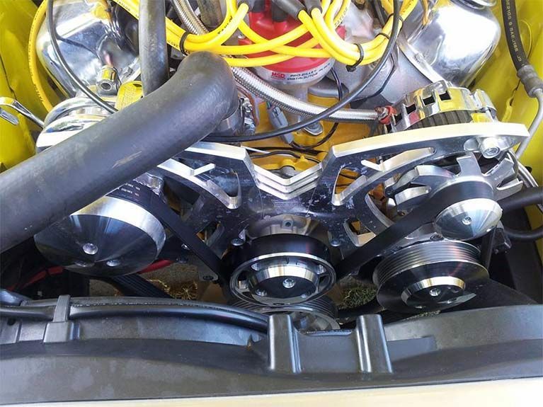 A close up of the engine of a yellow car
