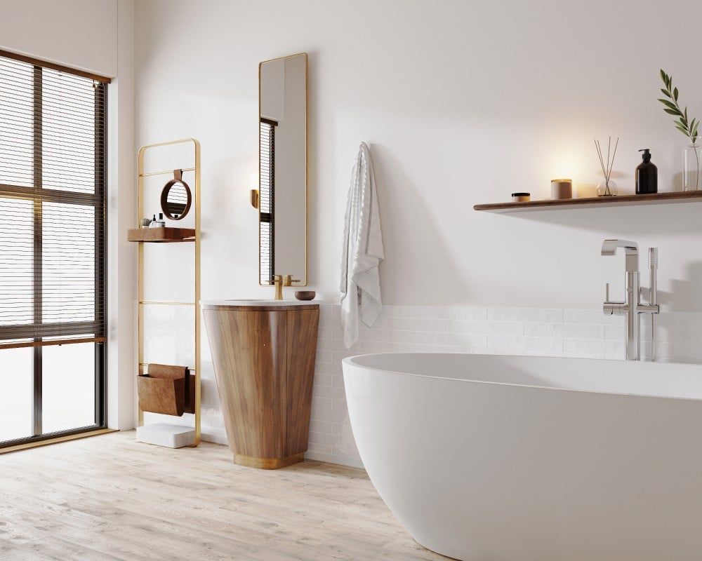 Modern bathroom with a freestanding tub, wood vanity, and gold accents.