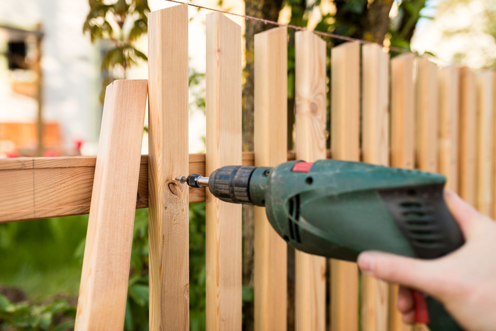 An expert from Fencing Solutions is performing wood fence installation for a new wooden fence in Joh