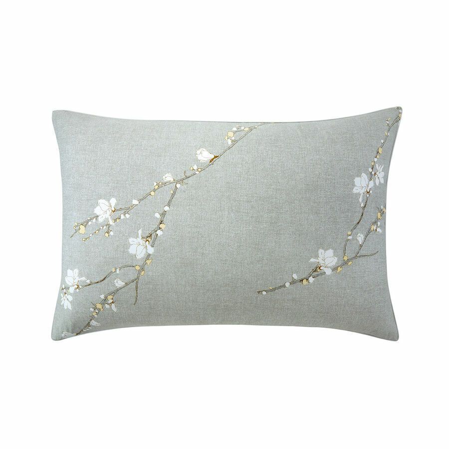 Un coussin gris avec des fleurs blanches dessus