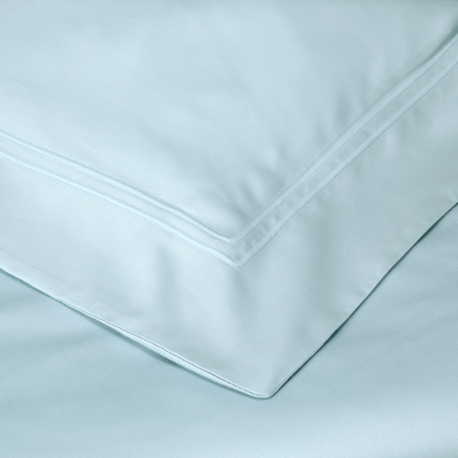 Un gros plan d'un oreiller blanc sur un lit.
