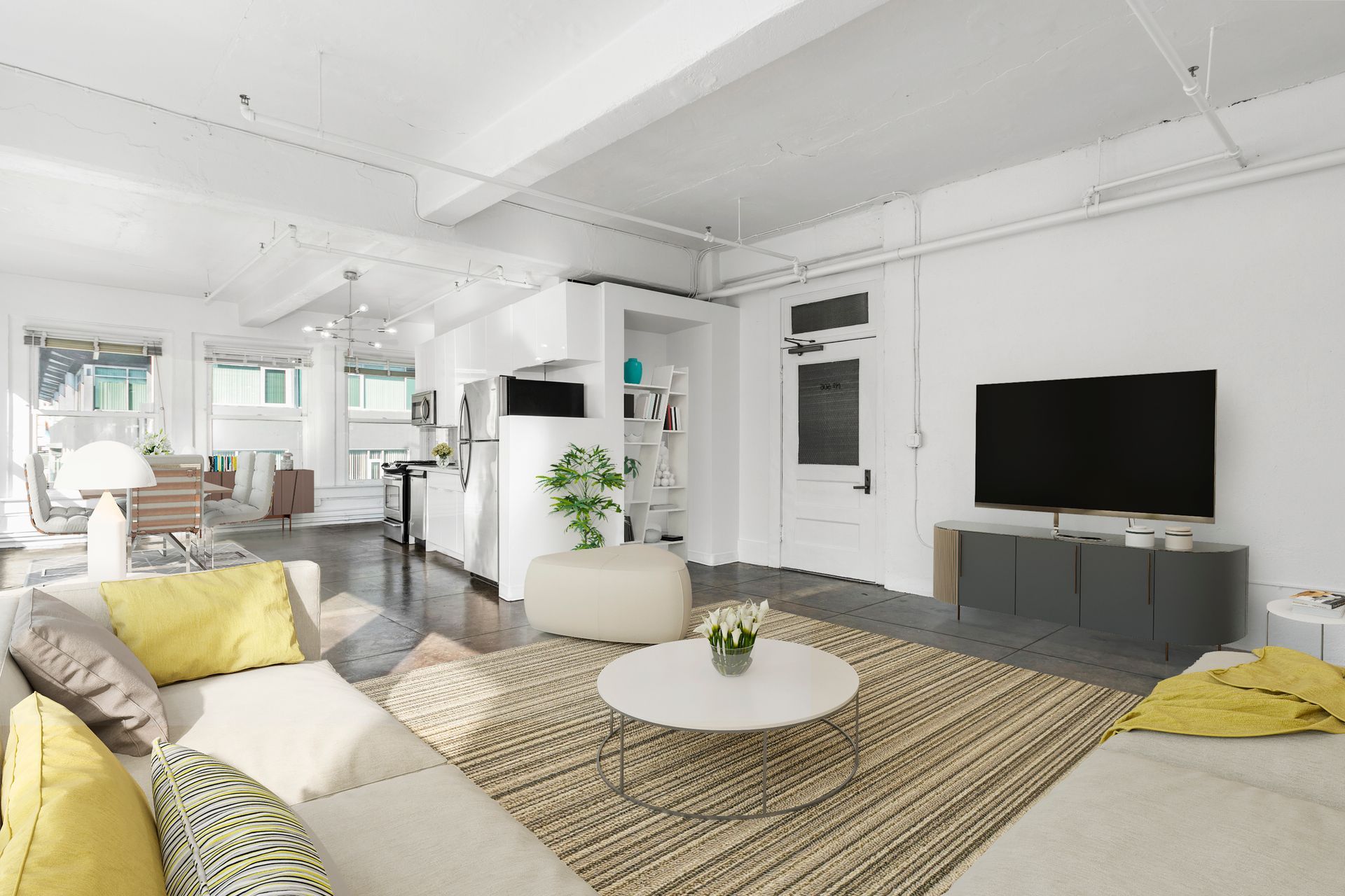 Bright modern living room with white walls, gray sofa, yellow pillows, rug, coffee table, and TV console