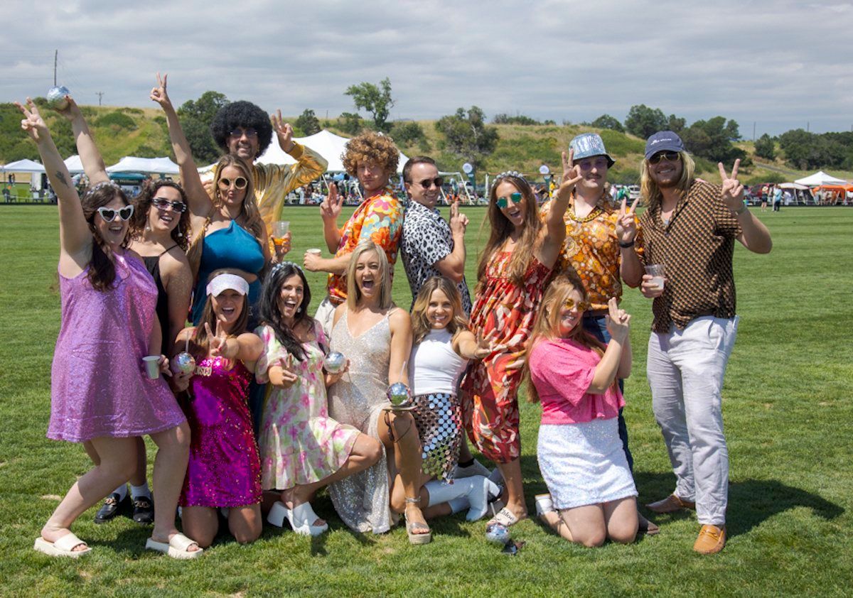 A group of people are posing for a picture in a field.