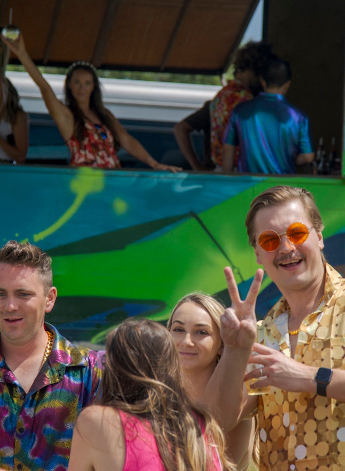 A group of people are standing next to each other in front of a bus.