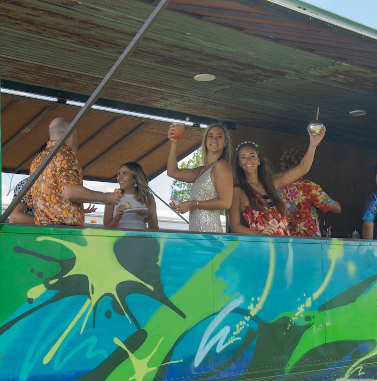 A group of people standing on top of a green and blue wall