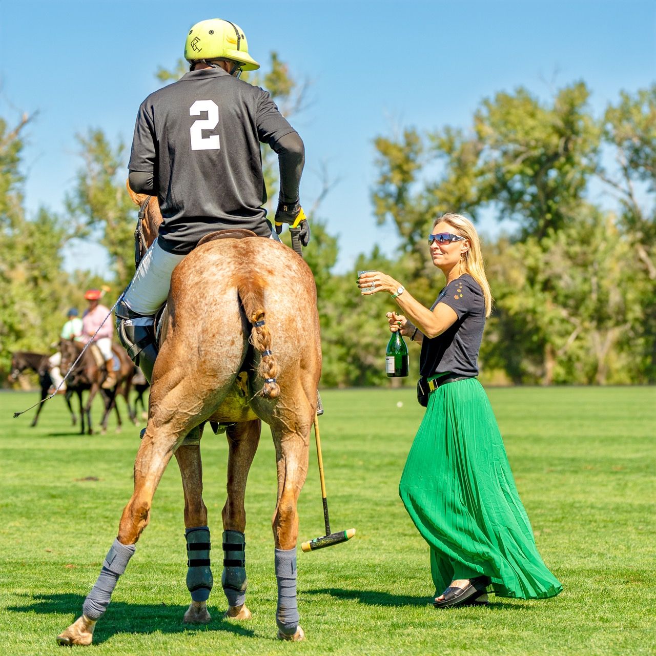 A man riding a horse with the number 2 on his back