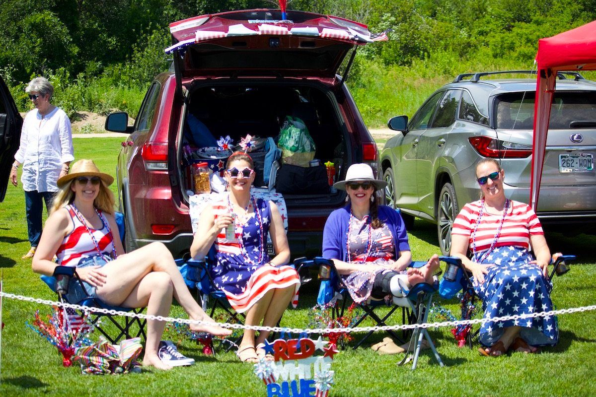 A group of women are sitting in the back of a car.