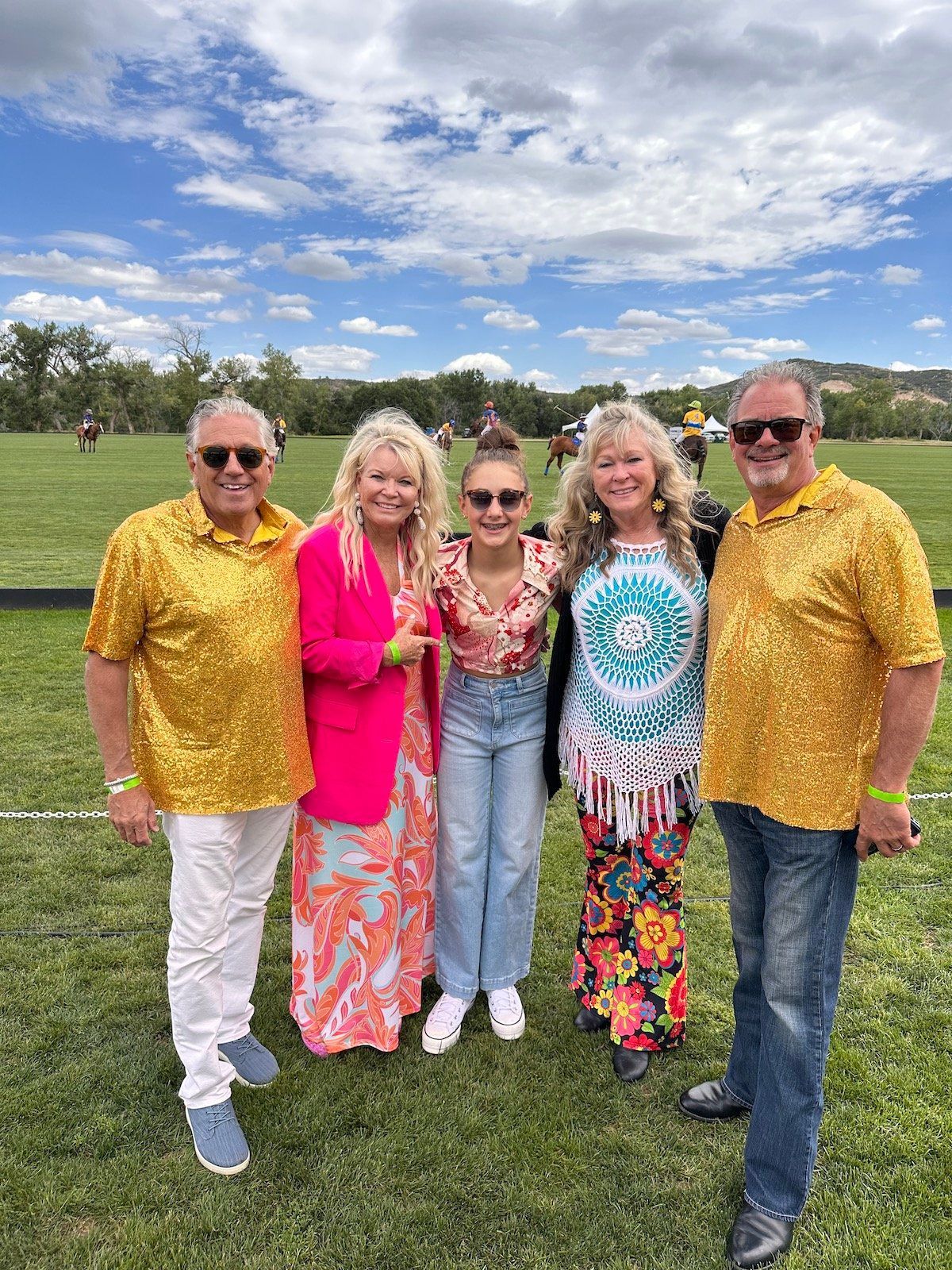A group of people are posing for a picture in a field.