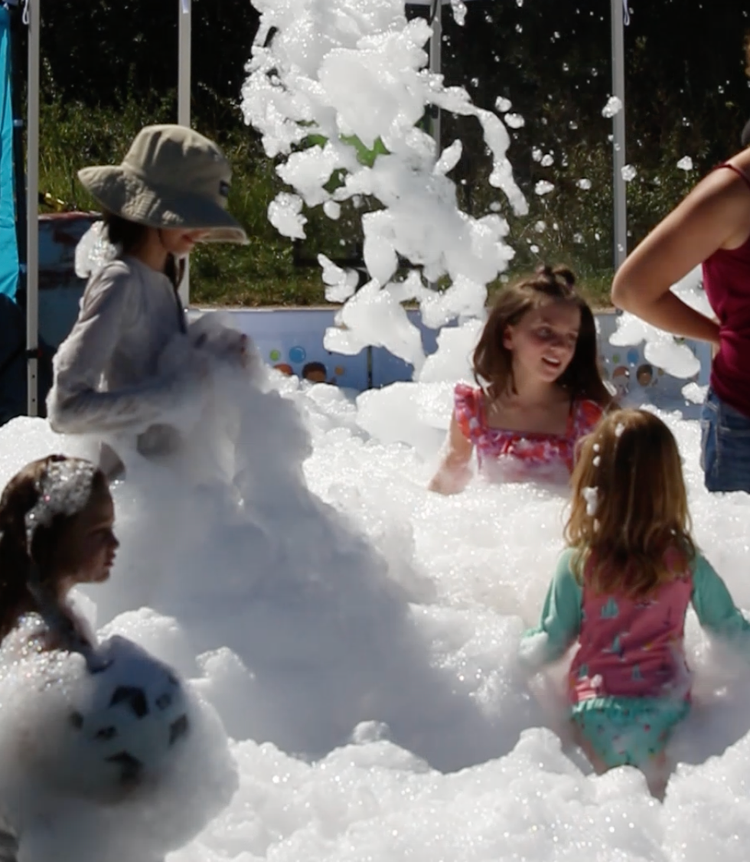 A group of children are playing in a pool of foam