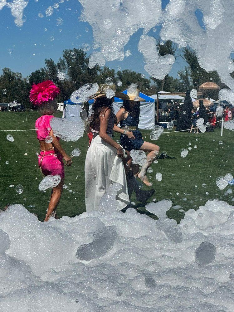 A group of people are standing in a field of foam.
