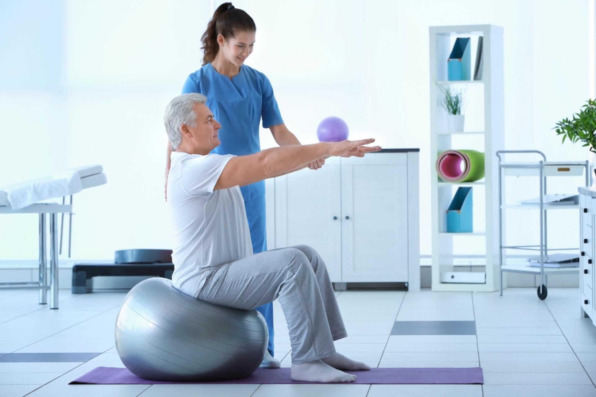 Physical Therapist Assisting a Seated Patient
