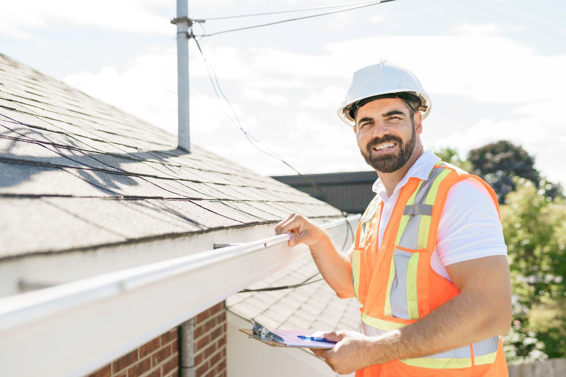 ACR Contracting technician next to a roof before servicing.
