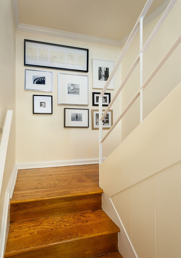 A staircase with wooden steps and a white railing.