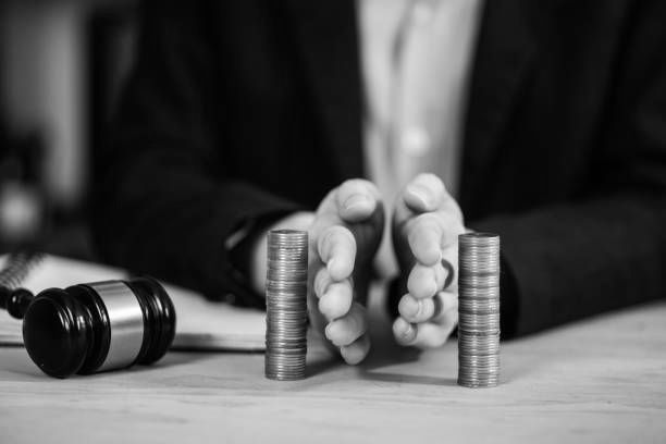 A person is holding a stack of coins in their hands.