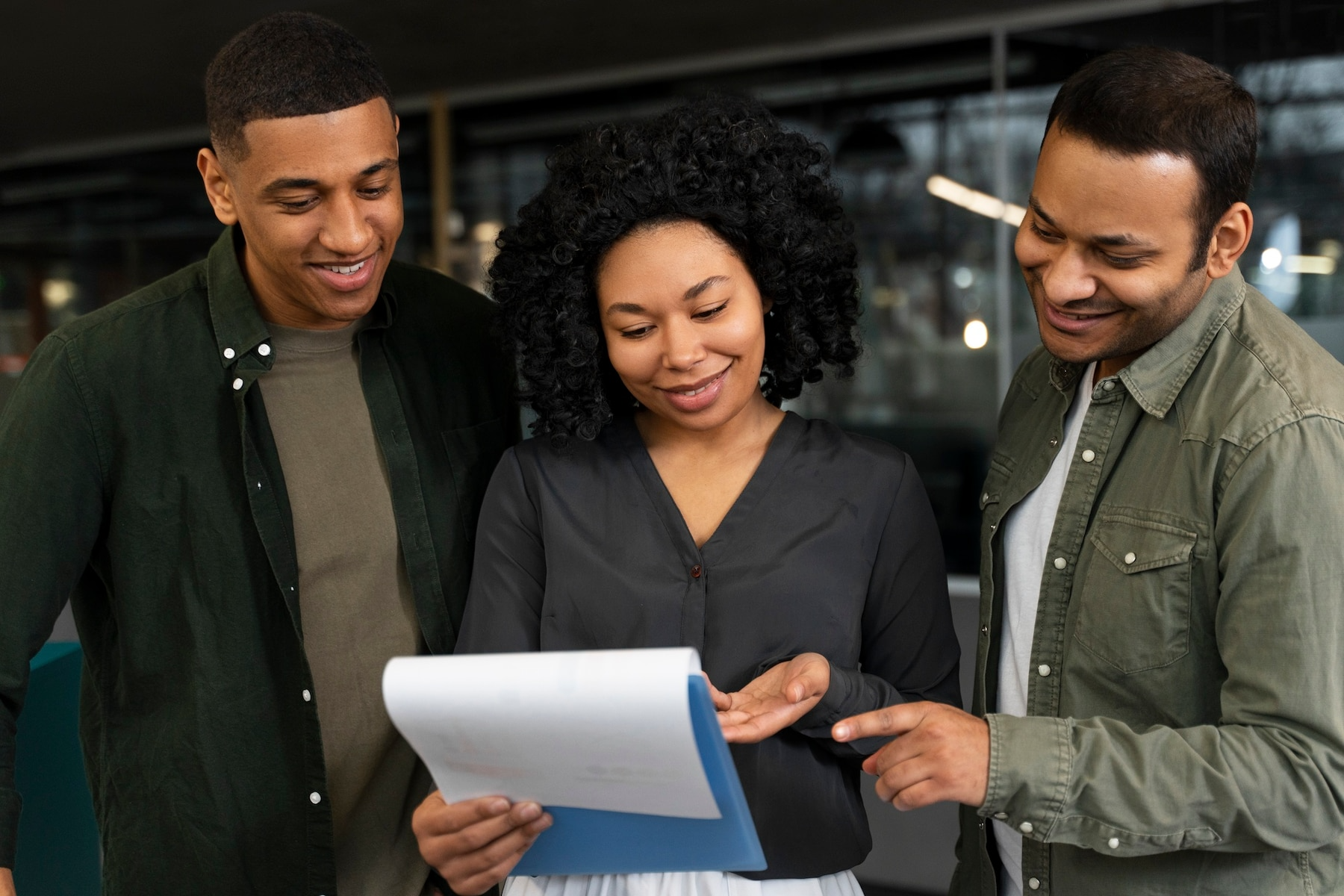 A group of people are looking at a piece of paper.