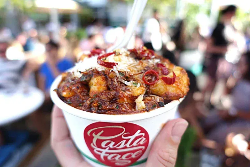 Beef ragu with potato gnocchi served in a branded Pasta Face cup
