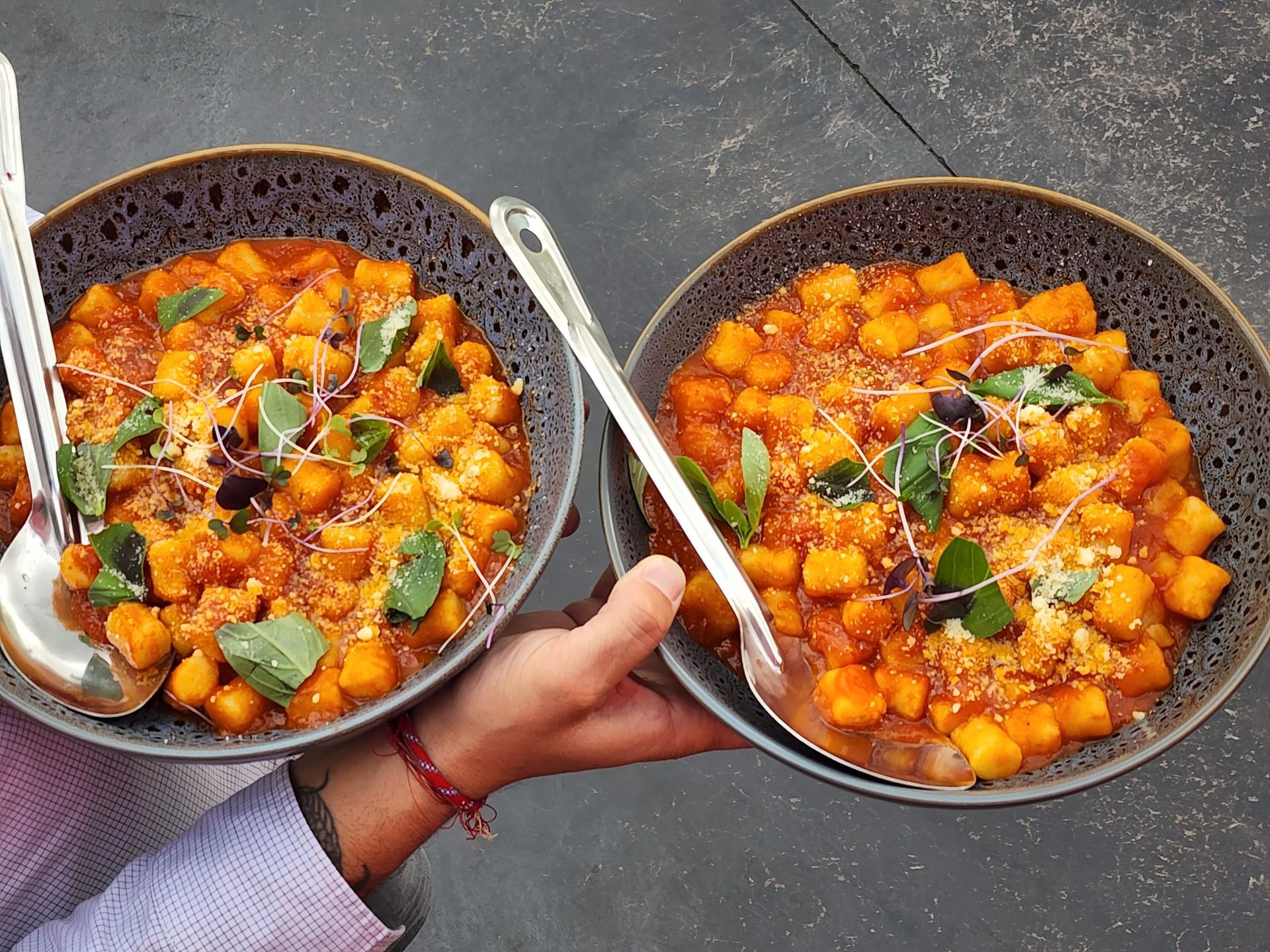 Shared bowls of Pasta Face gnocchi served for an Italian wedding feast